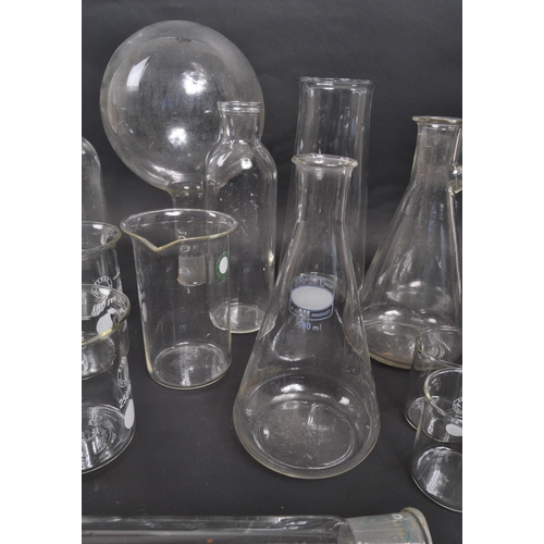 226 - A large collection of scientific / laboratory glass vessels comprising of beakers, conical flask, fl... 