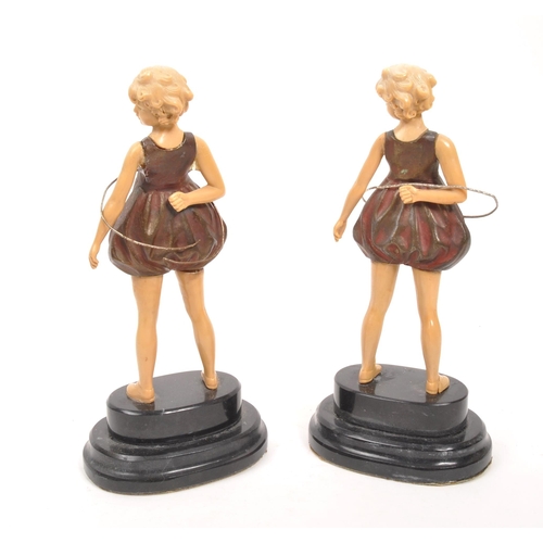 238 - A pair of 20th century Art Deco manner hula hoop figures. The figures having cold painted bronze bod... 