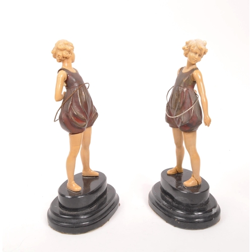 238 - A pair of 20th century Art Deco manner hula hoop figures. The figures having cold painted bronze bod... 