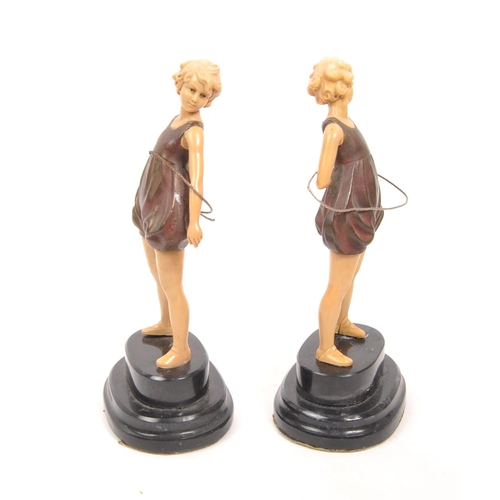 238 - A pair of 20th century Art Deco manner hula hoop figures. The figures having cold painted bronze bod... 