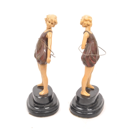 238 - A pair of 20th century Art Deco manner hula hoop figures. The figures having cold painted bronze bod... 