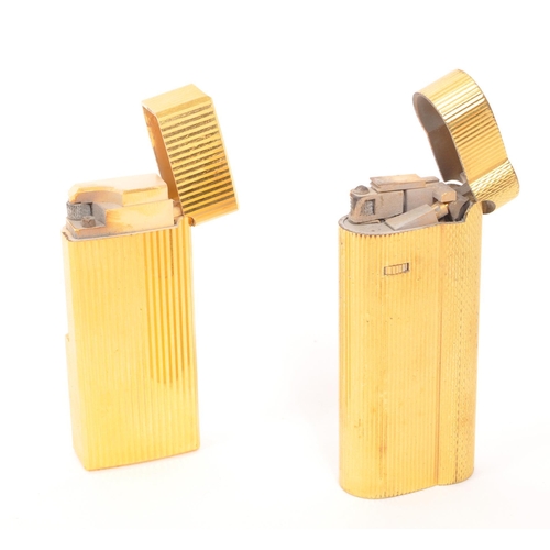 241 - Dunhill / Saffa - Two mid 20th century gold plated pocket cigarette lighters. Each lighter having an... 