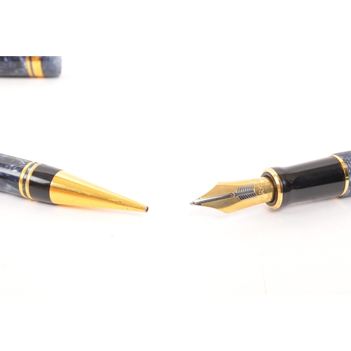 242 - Parker - A matching Parker DuoFold Centennial fountain pen and propelling pencil. Having marbled blu... 