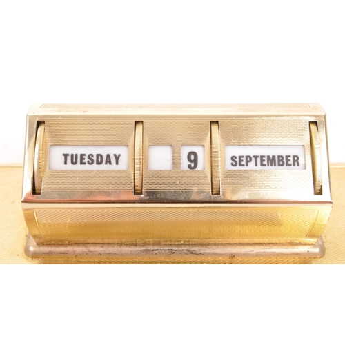 251 - A 20th Century vintage 1980s metal desktop perpetual calendar raised on rectangular base. Having rot... 