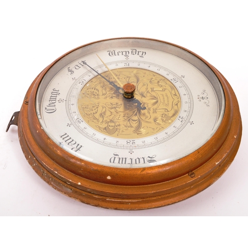 252 - A late 19th Century Victorian wall hanging aneroid barometer of circular form having engraved floral... 