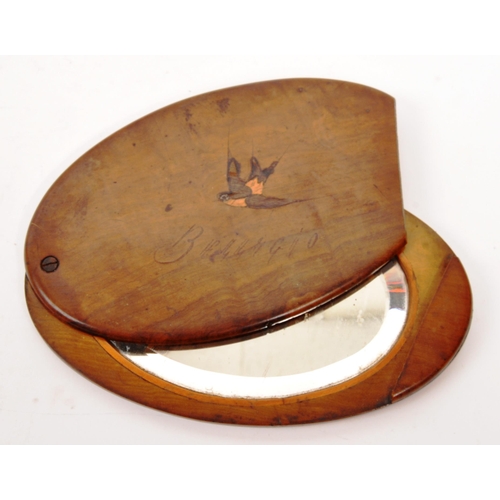 254 - An early 20th Century Edwardian walnut personalised handheld oval slide mirror having inlaid swallow... 