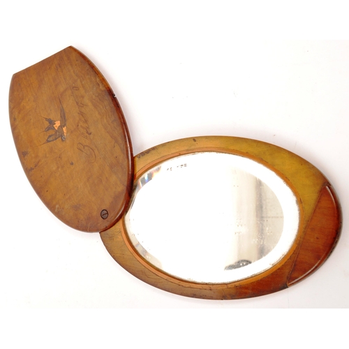 254 - An early 20th Century Edwardian walnut personalised handheld oval slide mirror having inlaid swallow... 