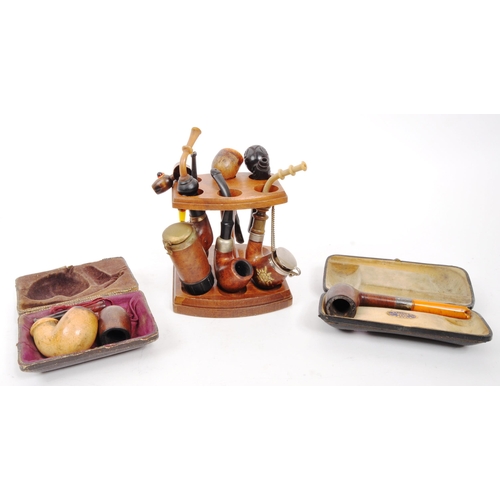 258 - A collection of 20th Century vintage smoking pipes to include two in cases and a wooden pipe holder.... 