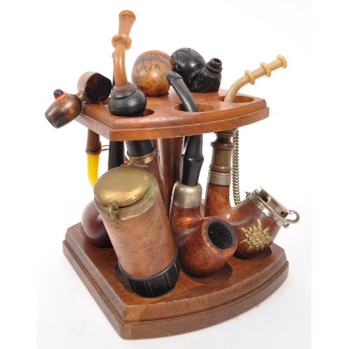 258 - A collection of 20th Century vintage smoking pipes to include two in cases and a wooden pipe holder.... 