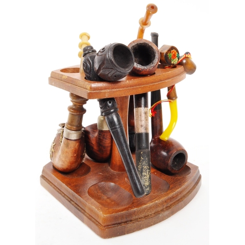 258 - A collection of 20th Century vintage smoking pipes to include two in cases and a wooden pipe holder.... 