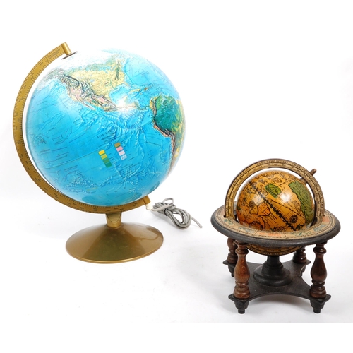 259 - Two 20th Century desktop globes the larger raised on circular base with light. The smaller within a ... 