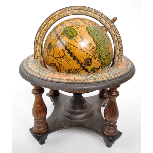 259 - Two 20th Century desktop globes the larger raised on circular base with light. The smaller within a ... 