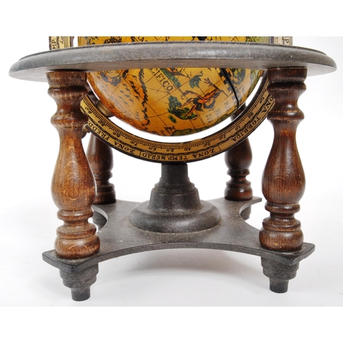 259 - Two 20th Century desktop globes the larger raised on circular base with light. The smaller within a ... 