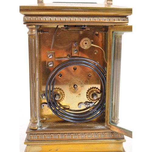 262 - An early 20th century brass carriage clock. With white face, ebonised chapter ring, with glass viewi... 