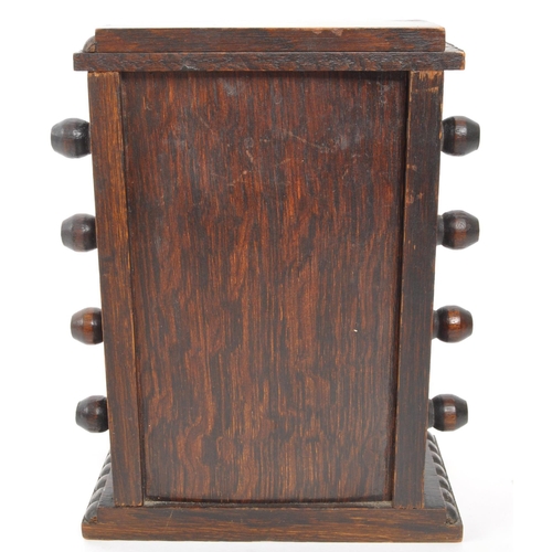 265 - An Edwardian oak perpetual desktop calendar having wrythen twist decoration to each side. Featuring ... 