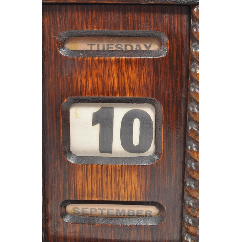 265 - An Edwardian oak perpetual desktop calendar having wrythen twist decoration to each side. Featuring ... 