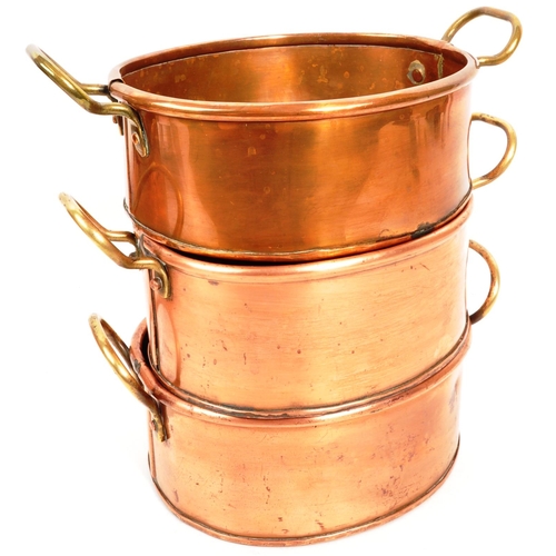 267 - A collection of four 20th Century vintage oval shaped graduating copper pans / planters having bras ... 