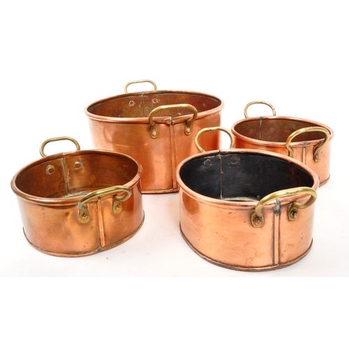 267 - A collection of four 20th Century vintage oval shaped graduating copper pans / planters having bras ... 