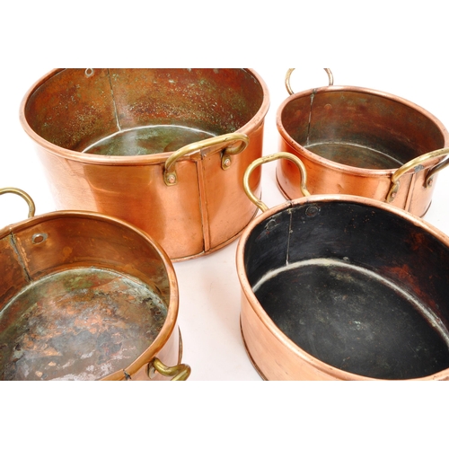 267 - A collection of four 20th Century vintage oval shaped graduating copper pans / planters having bras ... 