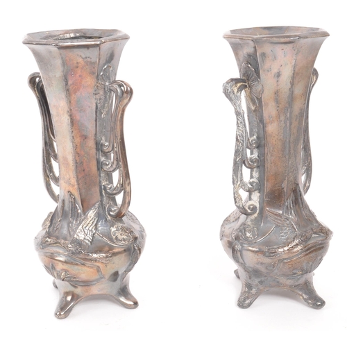 275 - A pair of early 20th Century Art Nouveau pewter German vases raised on four legs. Having rounded squ... 