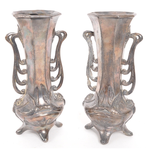 275 - A pair of early 20th Century Art Nouveau pewter German vases raised on four legs. Having rounded squ... 