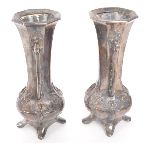 275 - A pair of early 20th Century Art Nouveau pewter German vases raised on four legs. Having rounded squ... 