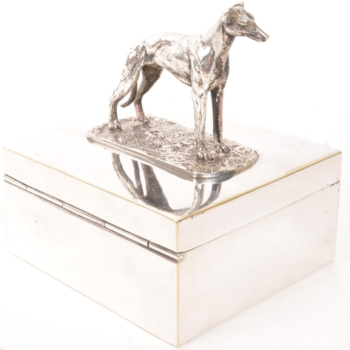 276 - A vintage 20th century greyhound top silver plate cigarette holder. With greyhound dog to top, on re... 