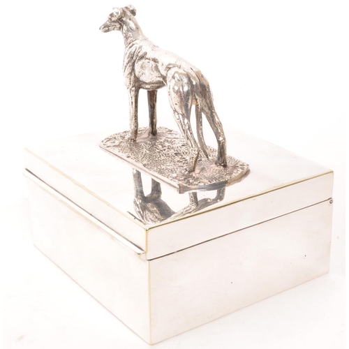 276 - A vintage 20th century greyhound top silver plate cigarette holder. With greyhound dog to top, on re... 