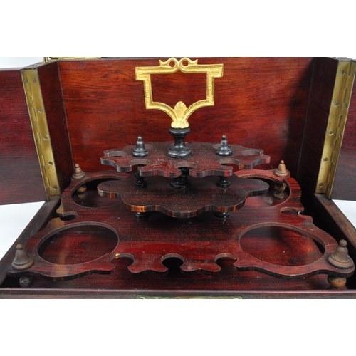 283 - An early 20th Century mahogany bell tantalus drinks box with four decanter lift out fitted interior.... 