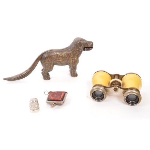 301 - A Victorian 19th century nut cracker in the form of a dog with a pair of theatre opera binoculars. T... 