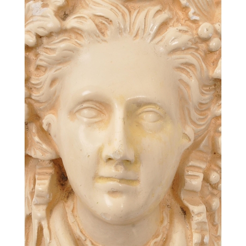 312 - A cast plaster wall scone of the Etruscan goddess Minerva. The sconce featuring a relief portrait to... 