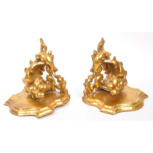 317 - A pair of 19th Century wooden gilt painted hall sconces / shelves. Having acanthus style foliate to ... 