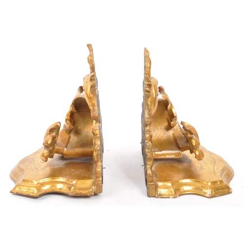 317 - A pair of 19th Century wooden gilt painted hall sconces / shelves. Having acanthus style foliate to ... 