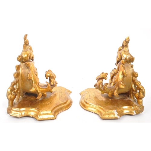 317 - A pair of 19th Century wooden gilt painted hall sconces / shelves. Having acanthus style foliate to ... 