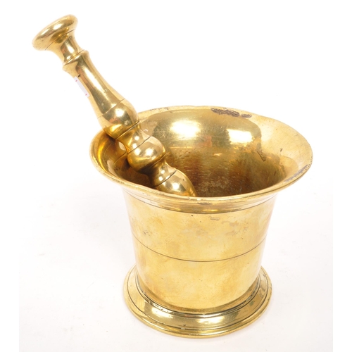 319 - A vintage 20th brass pestle and mortar. With a baluster shaped pestle and tapering circular mortar. ... 