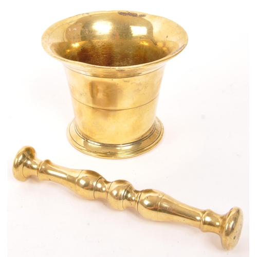 319 - A vintage 20th brass pestle and mortar. With a baluster shaped pestle and tapering circular mortar. ... 