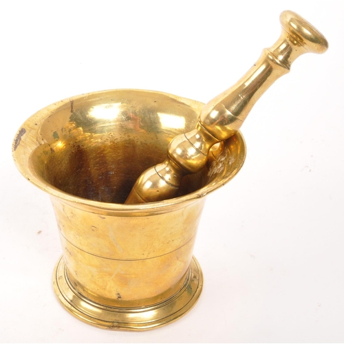 319 - A vintage 20th brass pestle and mortar. With a baluster shaped pestle and tapering circular mortar. ... 