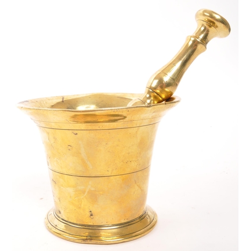 319 - A vintage 20th brass pestle and mortar. With a baluster shaped pestle and tapering circular mortar. ... 