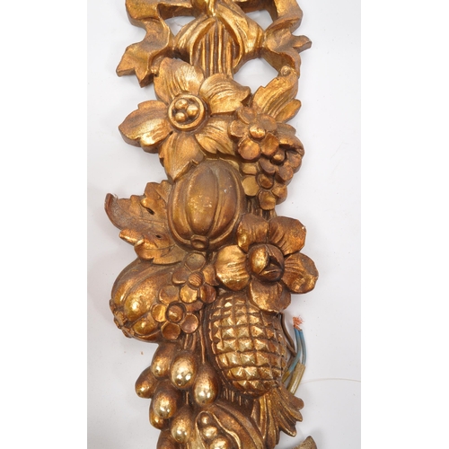 320 - A pair of 19th Century wooden gilt painted wall sconce lights. Each having twin scroll arms against ... 