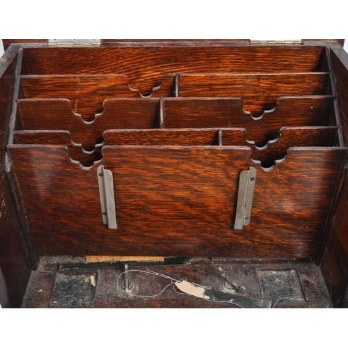 321 - An early 20th century oak wood desk tidy. The desk tidy having a hinged lid and front, with an appoi... 