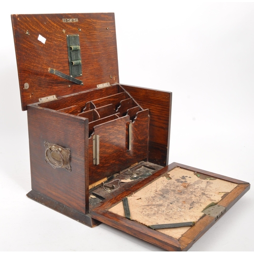 321 - An early 20th century oak wood desk tidy. The desk tidy having a hinged lid and front, with an appoi... 