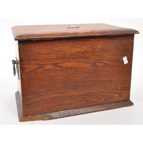 321 - An early 20th century oak wood desk tidy. The desk tidy having a hinged lid and front, with an appoi... 