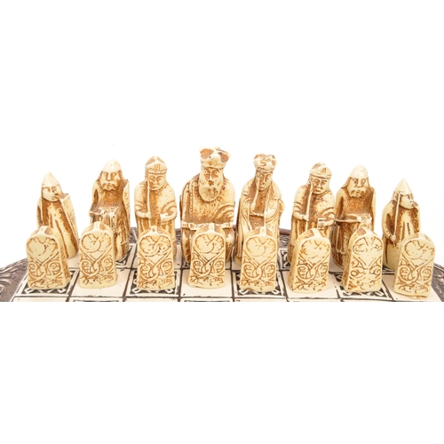 322 - The Lewis Chessman - A miniature set of resin chess pieces in the Isle of Lewis style modelled after... 