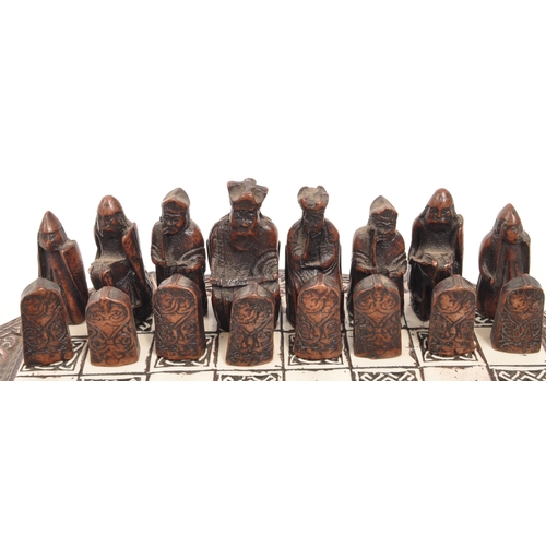 322 - The Lewis Chessman - A miniature set of resin chess pieces in the Isle of Lewis style modelled after... 