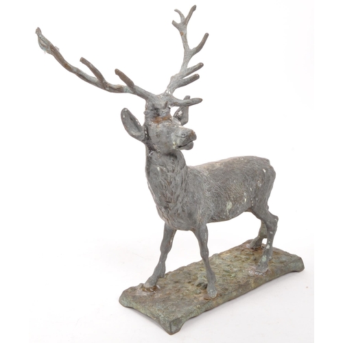 323 - A vintage 20th century cast bronze stag deer. With antler in a standing position on a base with rack... 