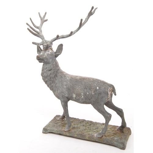 323 - A vintage 20th century cast bronze stag deer. With antler in a standing position on a base with rack... 