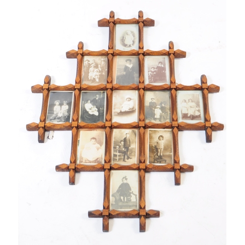 326 - Early 20th century wooden carved picture trap art style frame. In diamond form with monochrome postc... 