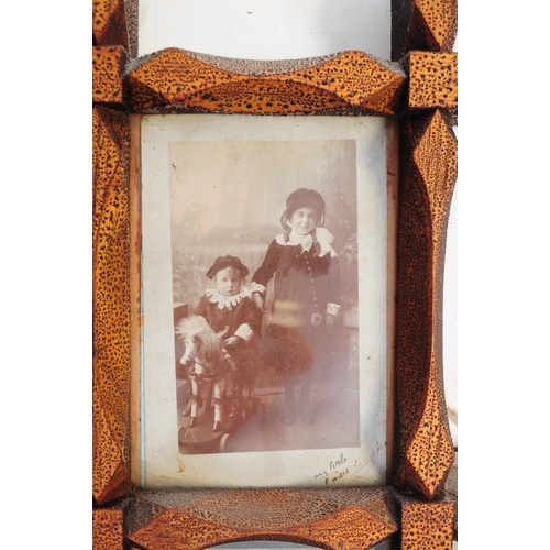 326 - Early 20th century wooden carved picture trap art style frame. In diamond form with monochrome postc... 