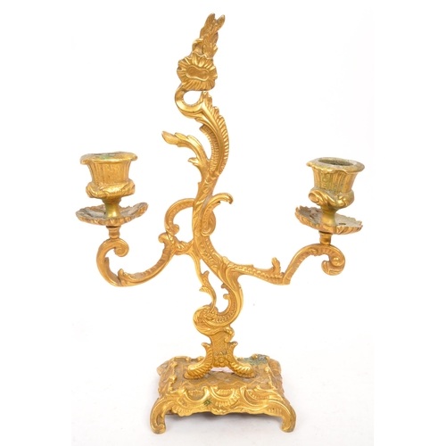 327 - W. T. & S - A early 20th century rococo Italian style gilt candelabra. With scrolled / flame middle ... 