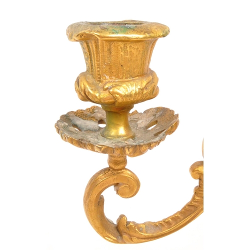 327 - W. T. & S - A early 20th century rococo Italian style gilt candelabra. With scrolled / flame middle ... 